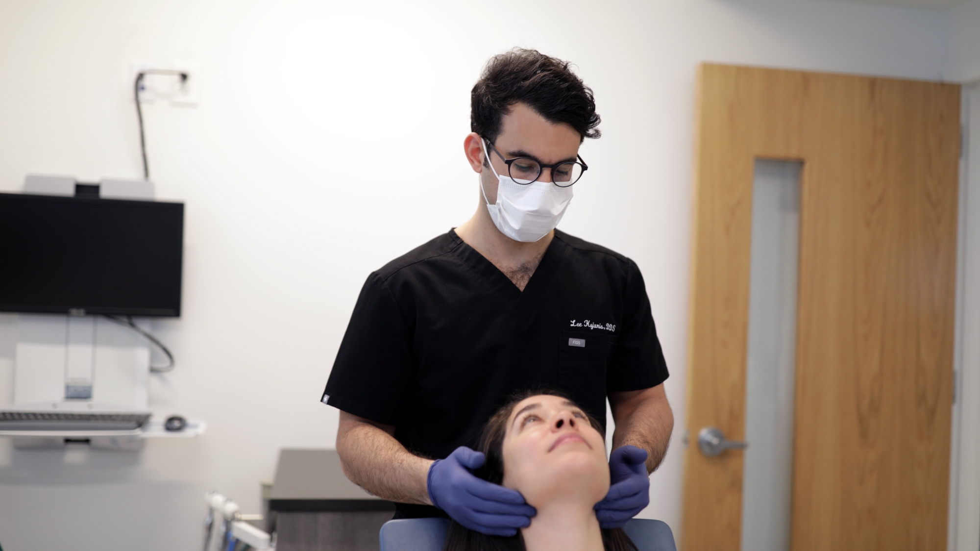 An expert oral surgeon examining a patient at Premier Oral.