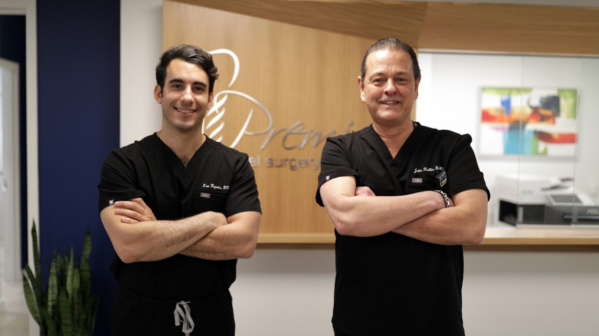 Two oral surgeons standing in a clinic, representing professional post-surgical care and patient support.