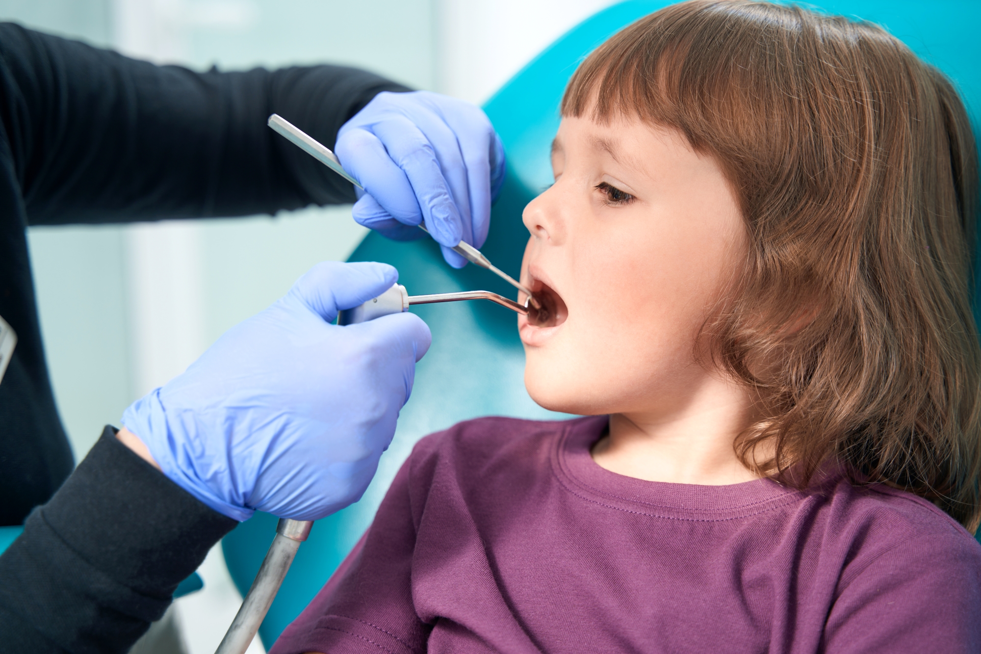Child having teeth examined at Premier Oral.