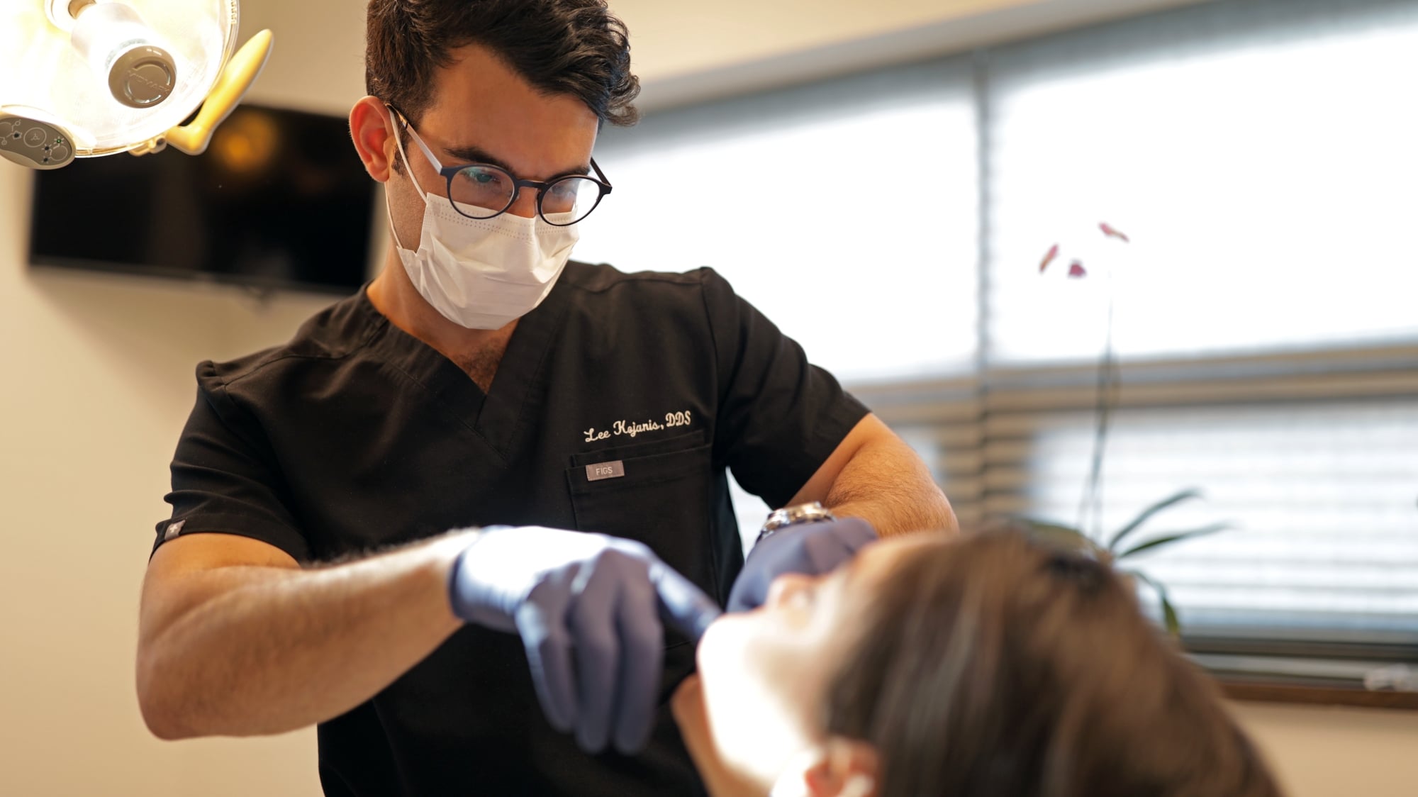 An expert surgeon performing a dental procedure at Premier Oral.