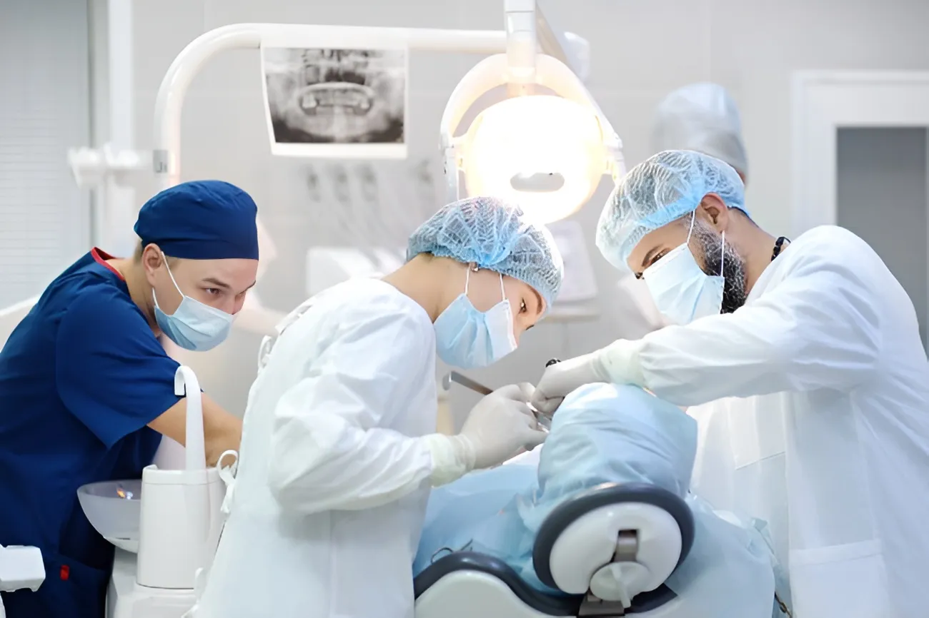 A team of surgeons performing a dental procedure on a patient at Premier Oral Surgery.