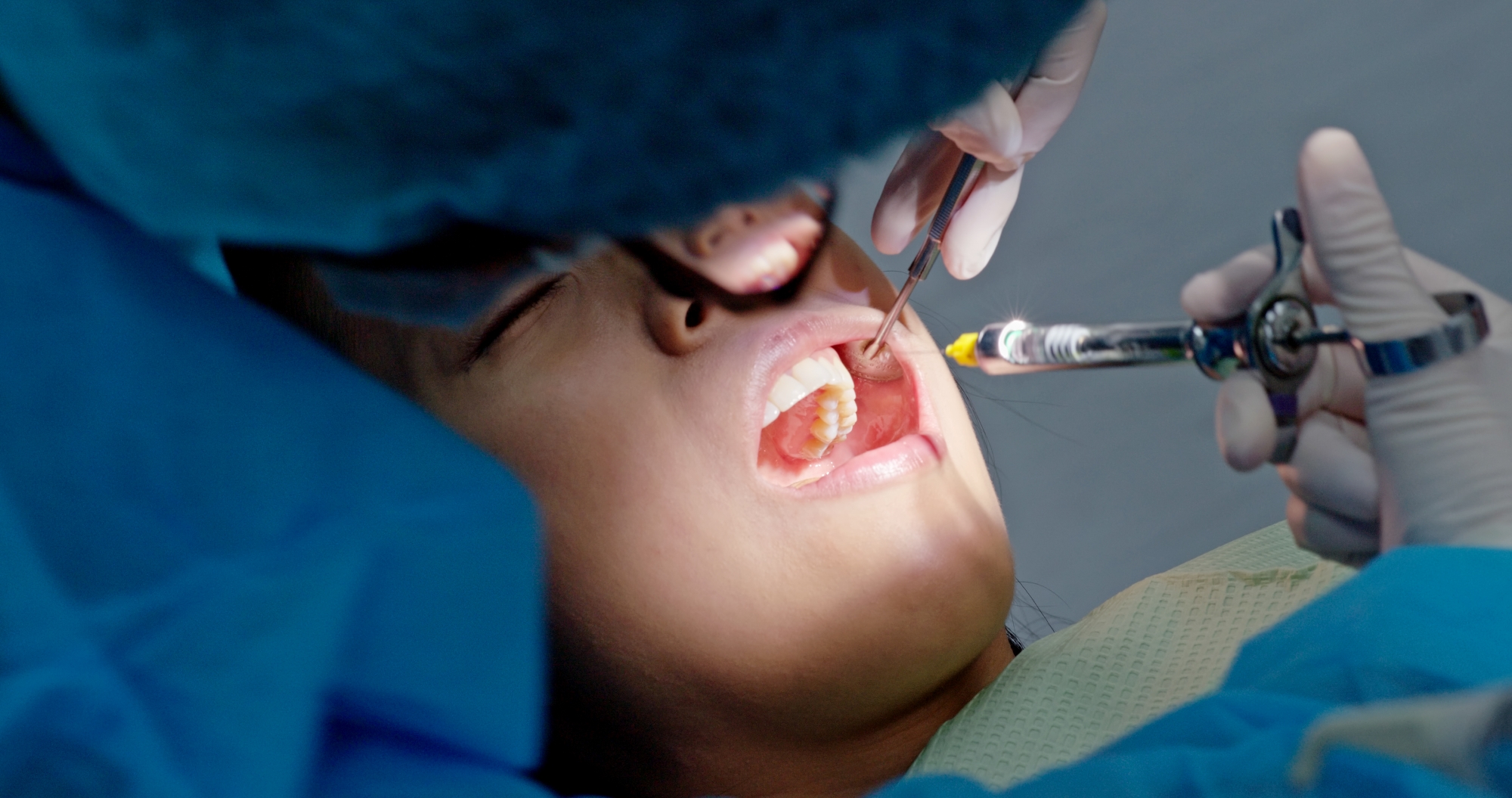 Woman receiving dental care at Premier Oral and Maxillofacial Surgery Group clinic.