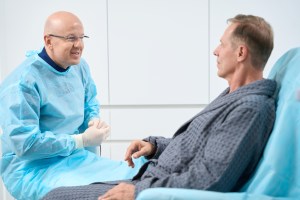 Oral surgeon explaining treatment plan to patient at Premier Oral.