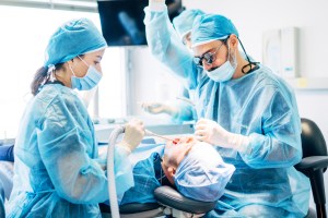 Surgeons performing a dental procedure at Premier Oral.