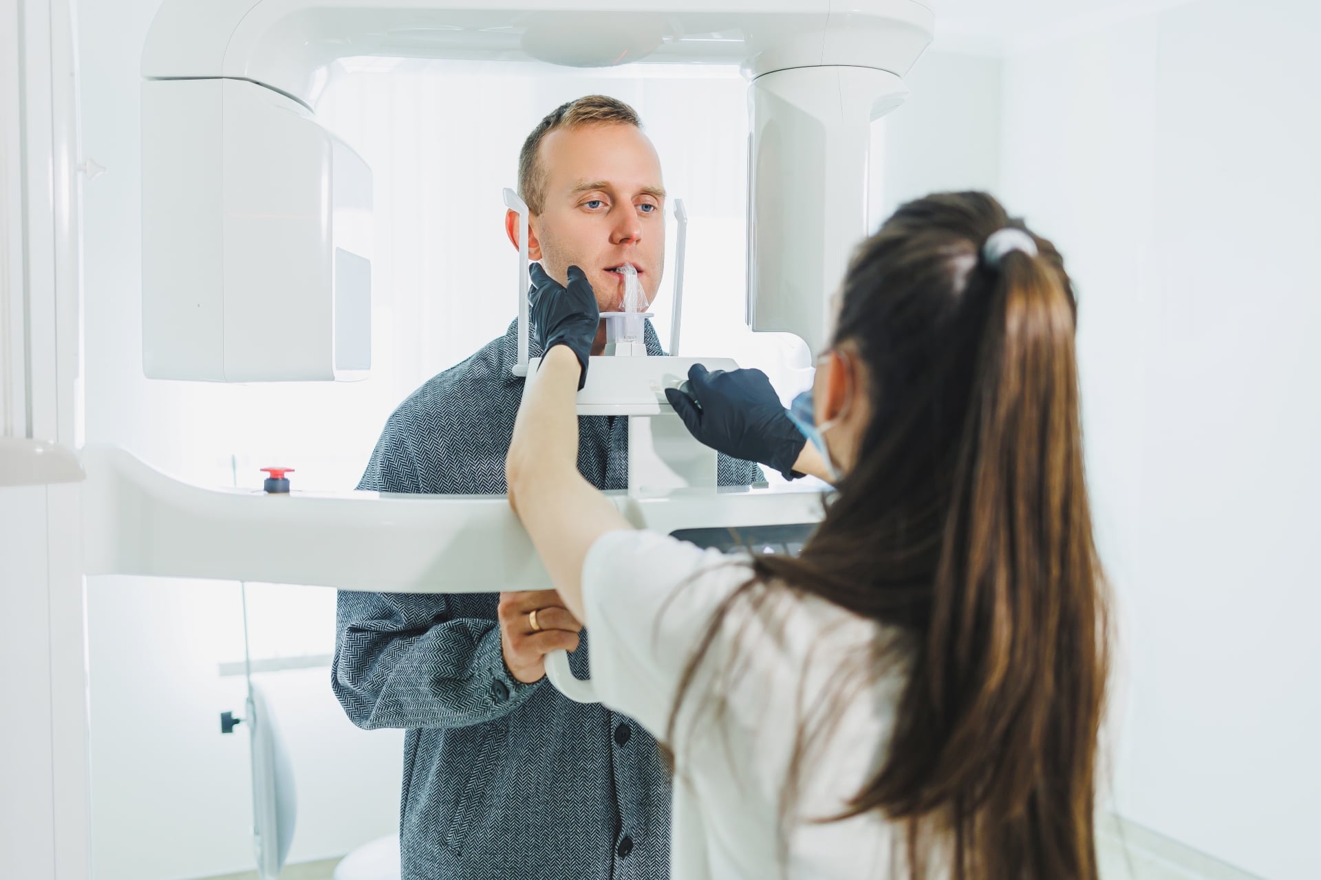 Dental specialist assists a male patient at Premier Oral.