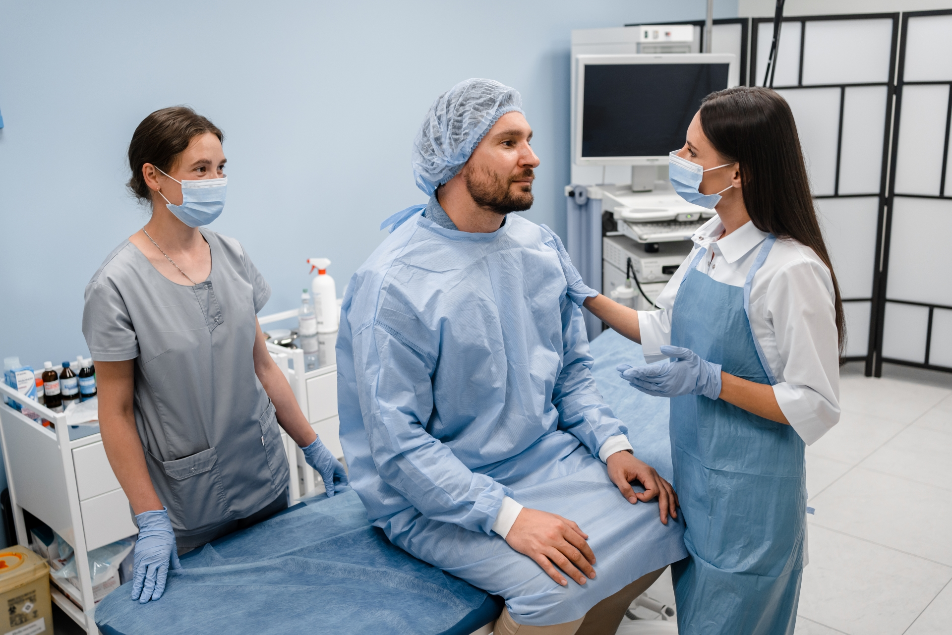 Patient discussing anesthesia and treatment plan with oral surgery team before procedure in clinic