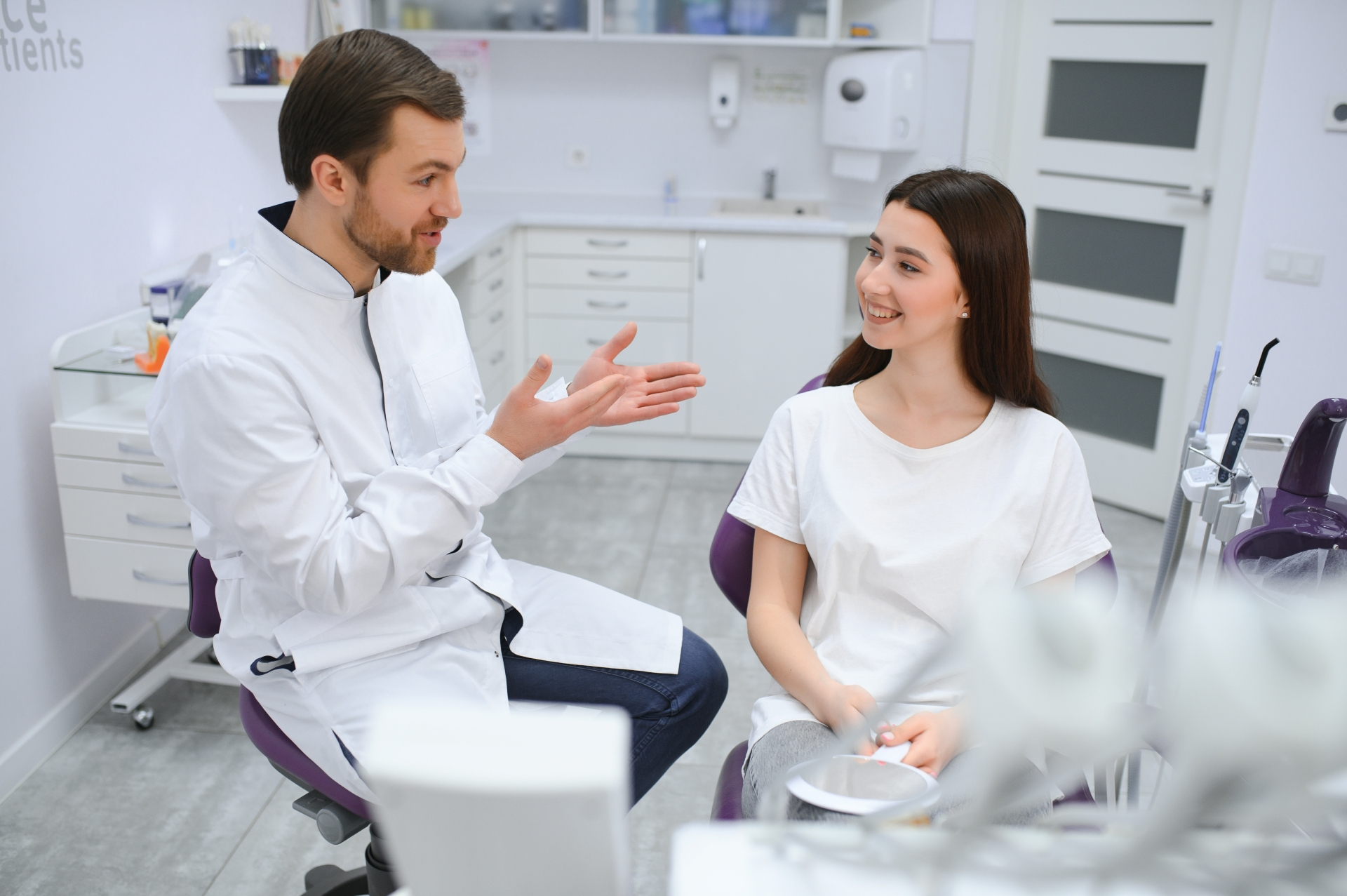 Patient discussing treatment options with oral surgeon during consultation at Premier Oral.