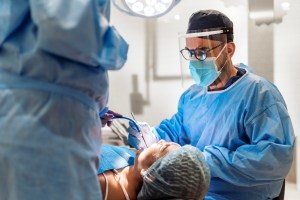 Premier Oral and Maxillofacial Surgery group surgeon performs a ridge preservation procedure on a patient.
