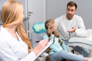 Parent and child discussing oral surgery with an oral surgeon at Premier Oral.