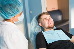 Patient receiving care during an oral surgery consultation at Premier Oral.