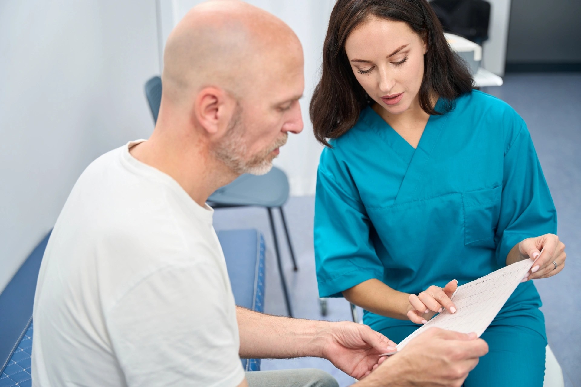 Oral surgery team member explaining treatment details to a patient during a consultation.